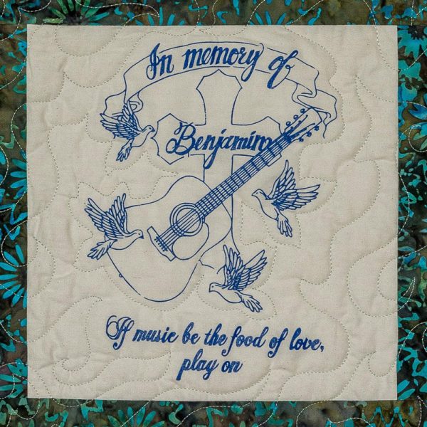 Quilt square for Benjamin Lucero with doves, a guitar, a cross, and text reading: If music be the food of love, play on