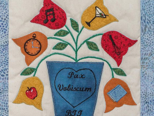 Quilt square for Benjamin Terrell with a plant and leaves with symbols of an apple, clock, music note, martini, whisk, and book.