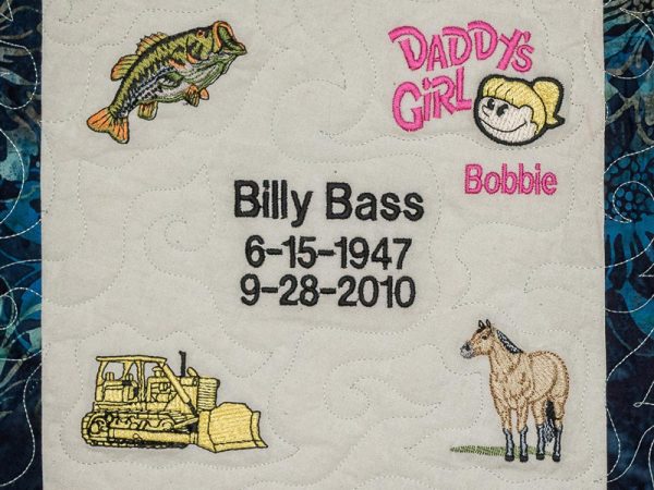 Quilt square for Billy Bass with a fish, tractor, horse, and text reading Daddy’s girl Bobbie.