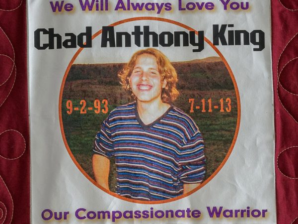 Quilt square for Chad King with a photo of Chad in an open field and text reading: We will always love you. Our compassionate warrior.