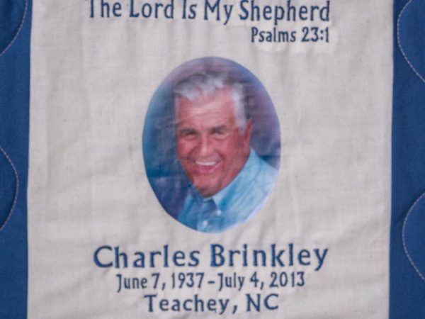 Quilt square for Charles Brinkley with portrait of Charles and text reading: The Lord is my shepherd. Psalms 23:1