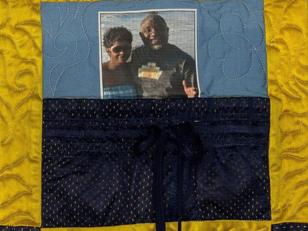 Quilt square for Charles Hill with a photo of Charles with family.