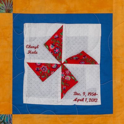Quilt square for Cheryl Hale red, blue and yellow, and a floral pattern.