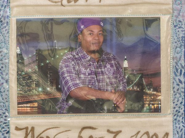 Quilt square for Demario Carr with portrait of Demario and backdrop of a city.