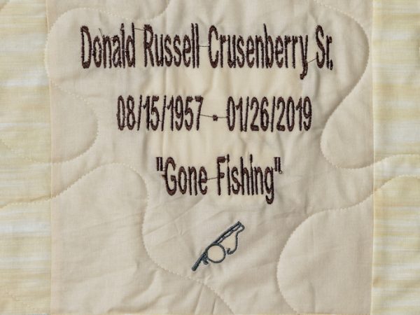 Quilt square for Donald Crusenberry with a patch of a fishing rod and text reading: Gone Fishing