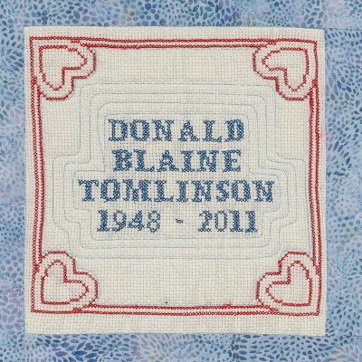 Quilt square for Donald Tomlinson with hearts in each corner.
