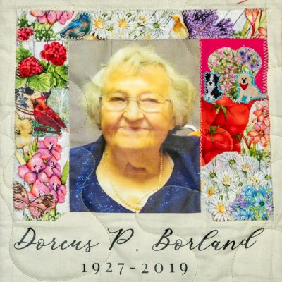 Quilt square for Dorcus Borland with portrait of Dorcus surrounded by animals and flowers