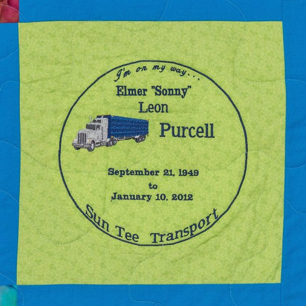Quilt square for Elmer Purcell with patch of a semitruck and text reading: I’m on my way