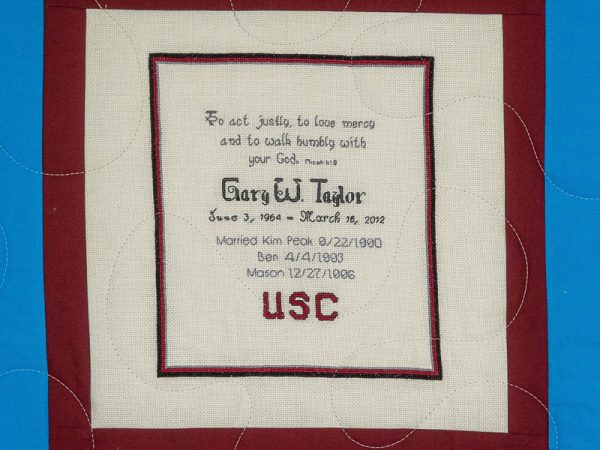 Quilt square for Gary Taylor with text reading: To act justly, to love mercy, and to walk humbly with your God. USC.