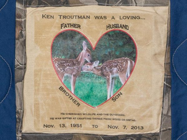 Quilt square for Ken Troutman with a photo of two fawns masked in the shape of a heart.
