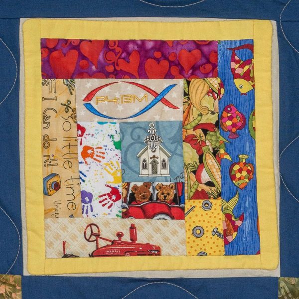 Quilt square for Glen F. Snader with a collage of squares featuring fish, nuts and bolts, fire engines, bears, hearts, a church, handprints, and vegetables