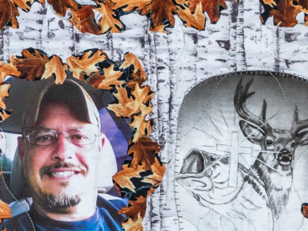 Quilt square for James Taylor with cross, deer, a selfie of James, and fall foliage
