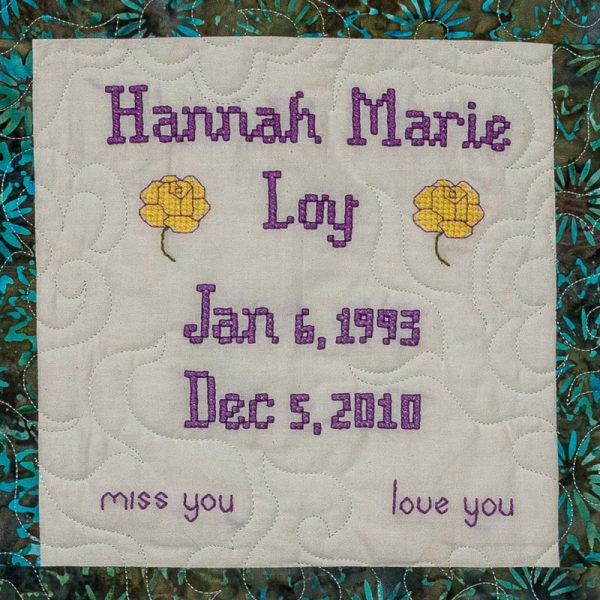 Quilt square for Hannah Marie Loy with two yellow roses and text reading: Miss you. Love you.