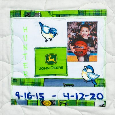 Quilt square for Hunter Ivey with John Deer logo, birds, and picture of Hunter holding a basketball