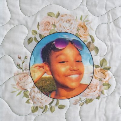 Quilt square for Imani McDonald with photo of Imani and flowers