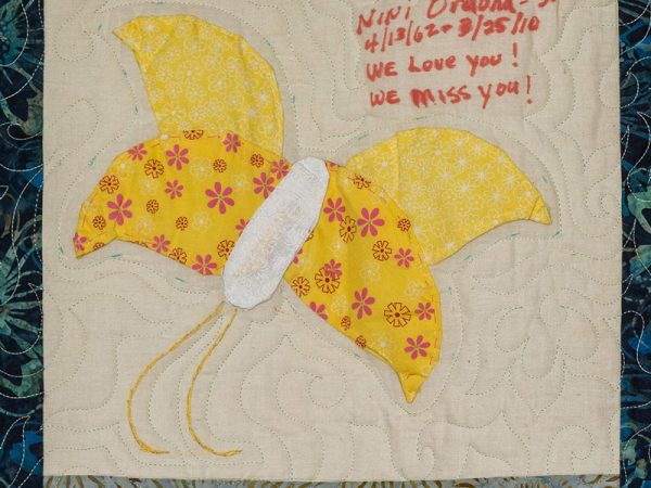 Quilt square for Jeannine Orduna-Skelton with a patch of a yellow butterfly.