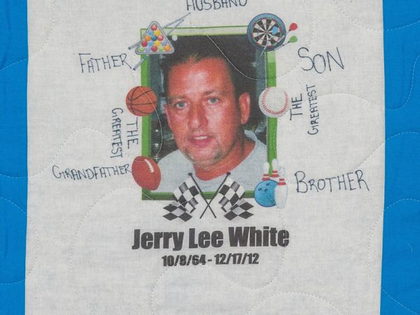 Quilt square for Jerry White with a portrait photo of Jerry and patches of pool, darts, basketball, football, baseball, bowling, and racing flags.