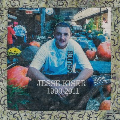 Quilt square for Jesse Kiser with a photo of Jesse sitting next to large pumpkins.