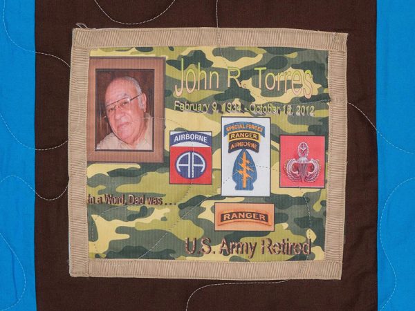 Quilt square for John Torress with Photo of John and patches airborne, special forces, ranger, ranger, and US Army retired.