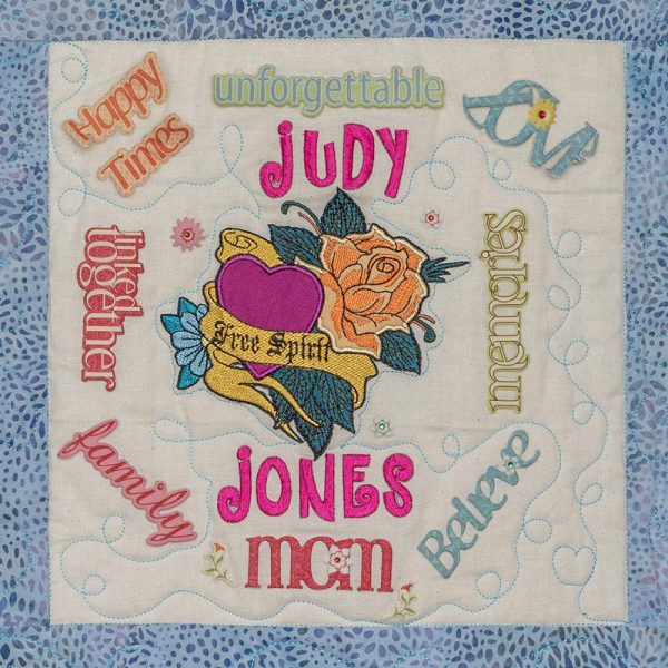 Quilt square for Judy Jones with flower and hearts and text reading free spirit. Happy Times, Unforgettable, Memories, Believe, Family, Linked Together.