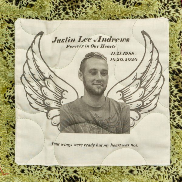 Quilt square for Justin Andrews with photo of Justin with angle wings and text reading: Forever in our hearts. Your Wings were ready but my heart was not.