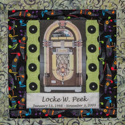 Quilt square for Locke Peek with a Juke Box at the center and a background of musical notes.