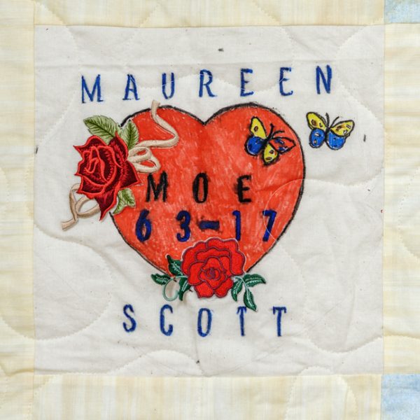 Quilt square for Maureen Scott with patches of a rose bud, heart, and butterflies