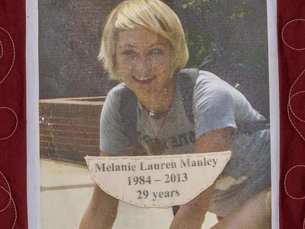 Quilt square for Melanie Manley with a photo of Melanie wearing a school backpack outside