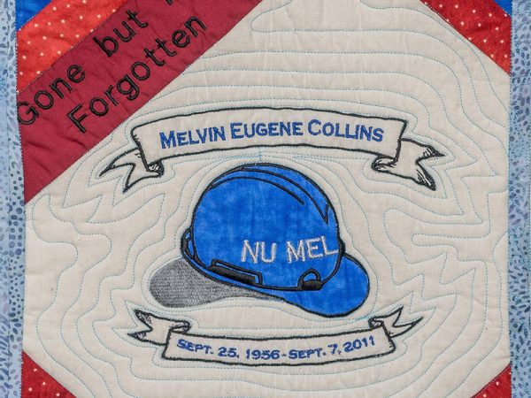 Quilt square for Melvin Eugene Collins with a hard hat and the words Nu Mel