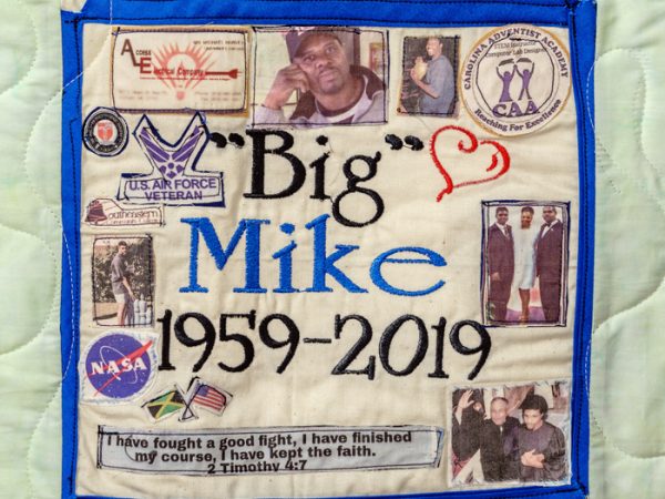 Quilt square for Michael Harvey with text reading Big Mike; photos of family; flags for America and Jamaica; logos of US Airforce, Nasa, and CAA
