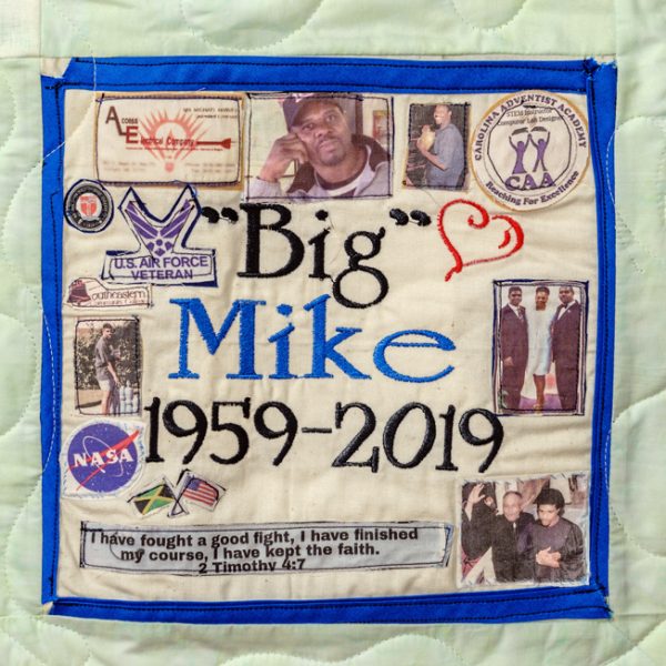 Quilt square for Michael Harvey with text reading Big Mike; photos of family; flags for America and Jamaica; logos of US Airforce, Nasa, and CAA