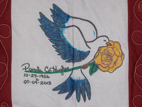 Quilt square for Pamela Hughes with a dove and a yellow rose.