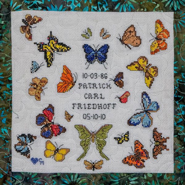 Quilt square for Patrick Friedhoff with many different types and colors of butterflies