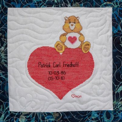 Quilt square for Patrick Friedhoff with picture patch of a bear and a heart.