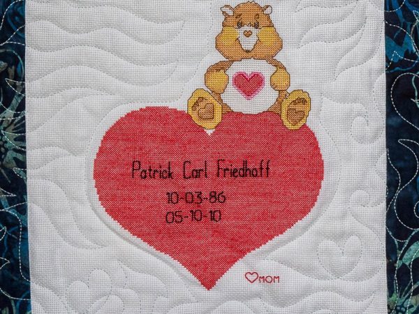 Quilt square for Patrick Friedhoff with picture patch of a bear and a heart.