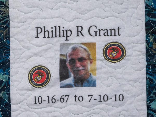 Quilt square for Phillip R Grant with marine corps logo and a portrait of Phillip.