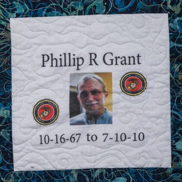 Quilt square for Phillip R Grant with marine corps logo and a portrait of Phillip.