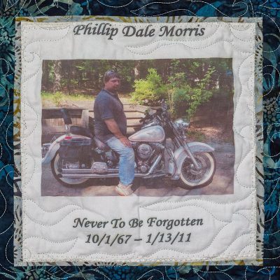 Quilt square for Phillip Dale Morris with a photo of Phillip on a motorcycle.