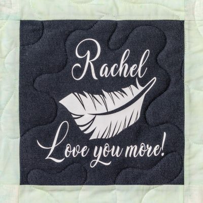 Quilt square for Rachel Wagner with feather and text reading: Love you more!