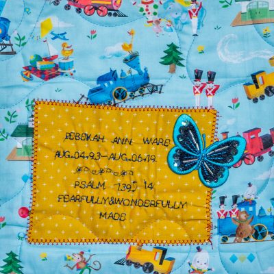 Quilt square for Rebekah Ware with toy trains, butterflies, and animals
