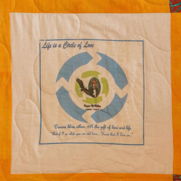 Quilt square for Reginald McMillan with arrows and text reading life is a circle of love. Donors bless others with the gift of love and life.
