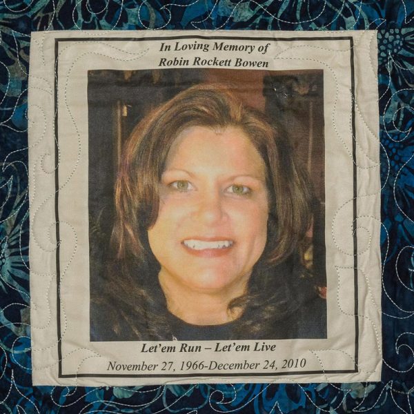 Quilt square for Robin Bowen with portrait of Robin and text reading: Let’em run – let’em live.
