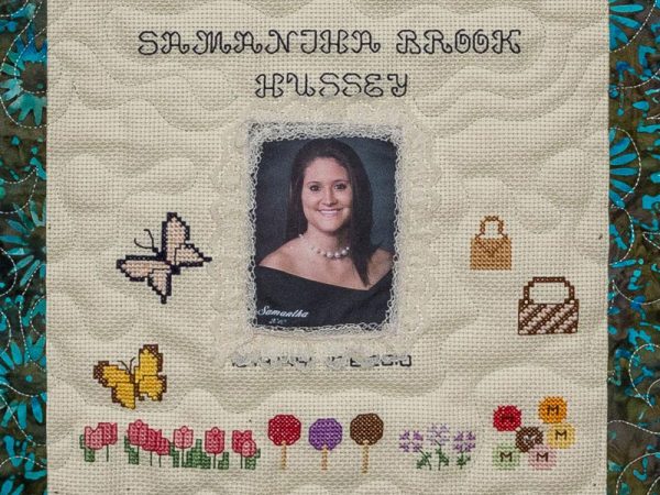 Quilt square for Samantha Hussey with purses, butterflies, flowers and a portrait of Samantha
