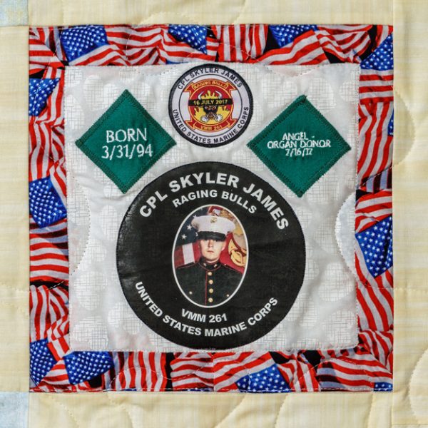 Quilt square for Skyler James with photo of Skyler in his Marine corps uniform and the background of an American flag