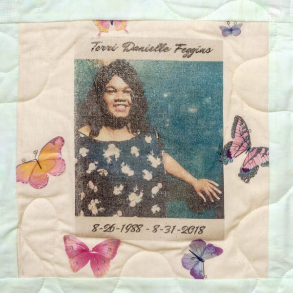 Quilt square for Terri Feggins with portrait of Terri and patches of butterflies