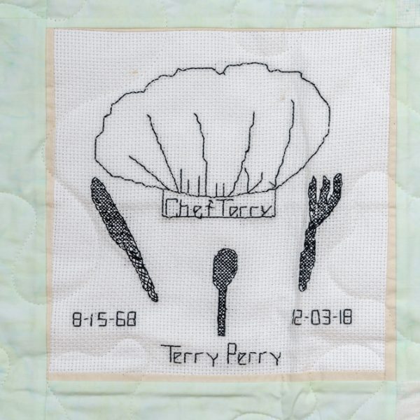 Quilt square for Terry Perry with knife, spoon, fork, and text reading: Chef Terry