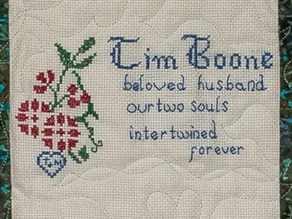 Quilt square for Tim Boon with text reading beloved husband our two souls intertwined forever.