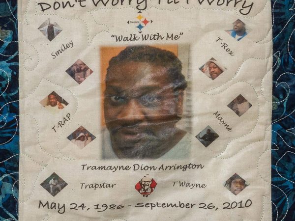 Quilt square for Tramayne Arrington with portrait of Tramayne and text reading: Smiley, T-Rap, Trapstar, T Wayne, Mayne, and T-Rex. Walk with me.