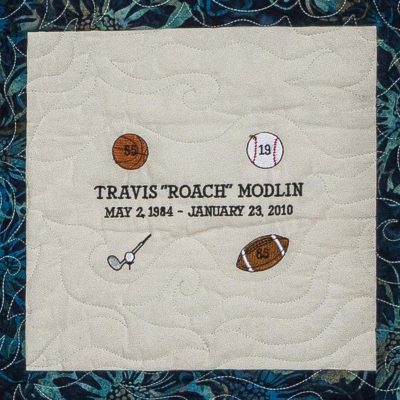 Quilt square for Travis Roach Modlin with a basketball, baseball, golf ball, and football.