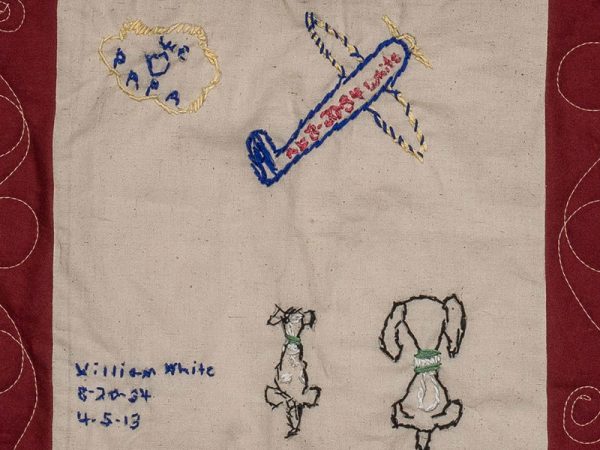 Quilt square for William Albert White with patches of two dogs, a plane, and a cloud with text reading: Papa.